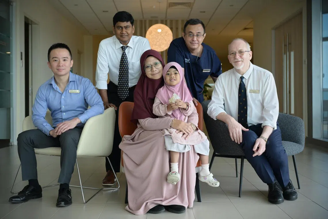 Nur Faathimah Assyifa’ and her mother Madam Nur Syahidah Watib with medical professionals (from left) Assistant Professor Chen Ching Kit, senior consultant at the division of paediatric cardiology in Khoo Teck Puat – National University Children’s Medical Institute (KTP-NUCMI) at NUH; Dr Senthil Kumar Subbian, consultant at NUHCS’ division of paediatric cardiac surgery; Assistant Professor Winn Maung Maung Aye, consultant at NUHCS’ division of paediatric cardiac surgery and Associate Professor Laszlo Kiraly, head and senior consultant at NUHCS department of cardiac, thoracic and vascular surgery. 