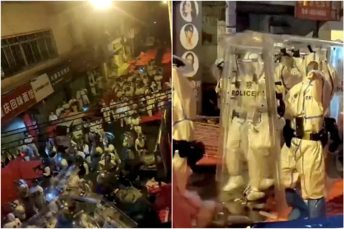 Screengrabs taken on Nov 30 of riot police in personal protection suits during a protest over Covid-19 restrictions in Guangzhou. 