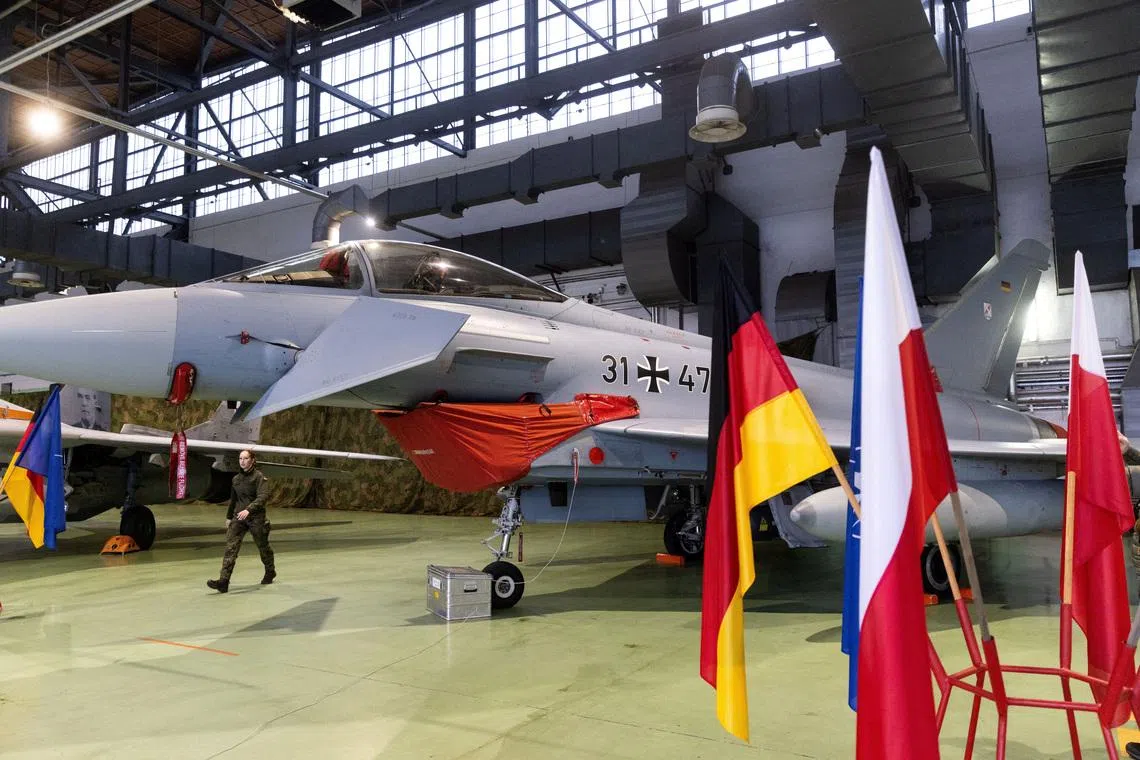 FILE PHOTO: A German Air Force Eurofighter Typhoon fighter jet is displayed in a hangar during the launch of the German contingent’s mission under NATO’s Air Policing operation at the 22nd Tactical Air Base in Malbork, Poland December 10, 2025. REUTERS/Lukasz Glowala/File Photo