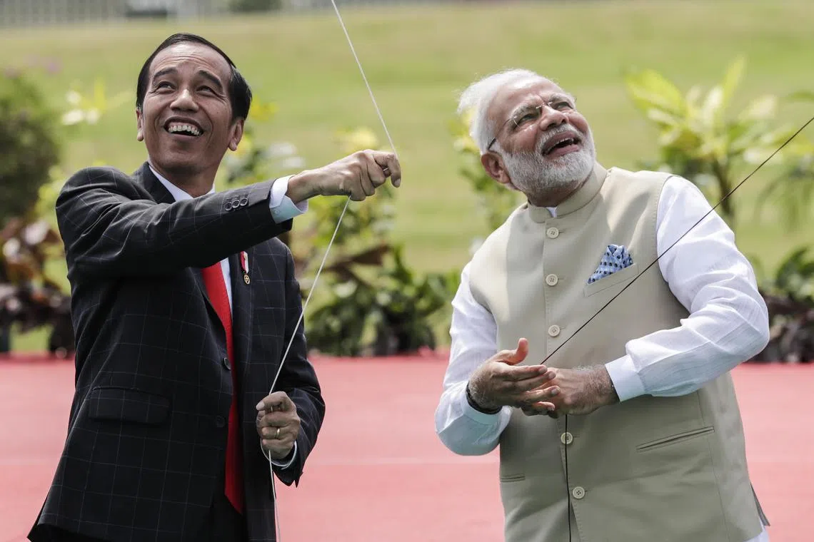 Indonesian President Joko Widodo (left) and Indian Prime Minister Narendra Modi fly kites at the opening ceremony of the India-Indonesia Kite Exhibition in Jakarta on May 30, 2018. 