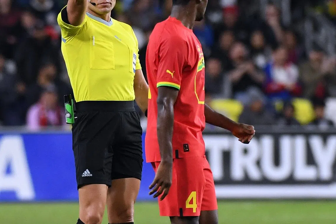 FILE PHOTO: Oct 17, 2023; Nashville, Tennessee, USA; Ghana midfielder Edmund Addo (4) is issued a yellow card by referee Marco Antonio Ortiz during the first half against the United States at GEODIS Park. Mandatory Credit: Christopher Hanewinckel-USA TODAY Sports/File Photo