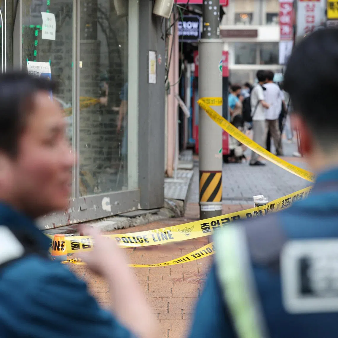 Policemen look at the scene of a stabbing attack by un identified man in his 30s in which one person was killed and three wounded near a subway station, in Seoul, South Korea, July 21, 2023.   Yonhap via REUTERS   THIS IMAGE HAS BEEN SUPPLIED BY A THIRD PARTY. NO RESALES. NO ARCHIVES. SOUTH KOREA OUT. NO COMMERCIAL OR EDITORIAL SALES IN SOUTH KOREA.