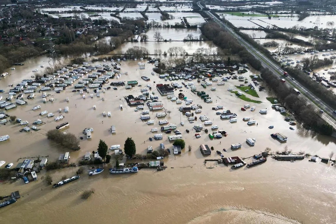 TOPSHOT - A photograph taken on January 7, 2025 shows an aerial view of a flooded caravan park, in Barrow upon Soar, central England, after heavy snow and rain across large parts of England caused disruption over the weekend. (Photo by Oli SCARFF / AFP)