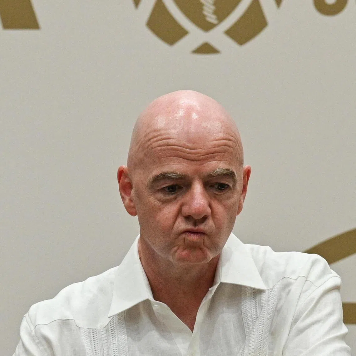 (FILES) FIFA President Gianni Infantino gestures during his visit to the new Concentration Hotel of the Colombian Football Federation in Barranquilla, Colombia, on February 24, 2026. FIFA president Gianni Infantino came under renewed fire on August 10, 2026 as a joint letter from three confederations -- UEFA, CONCACAF and AFC -- declared football "belongs to no individual". (Photo by David SALAZAR / AFP)