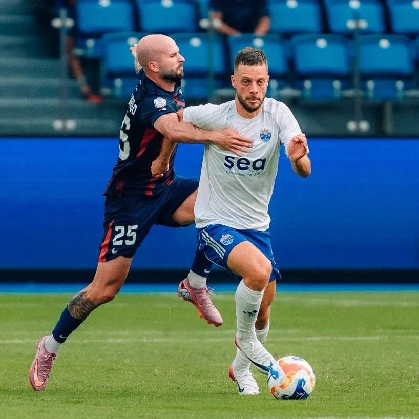 The Lion City Sailors' Bart Ramselaar, who recently penned a two-year contract extension, trying to shrug off Johor Darul Takzim's Joao Figueiredo during their 3-1 Shopee Cup defeat in August 2025.