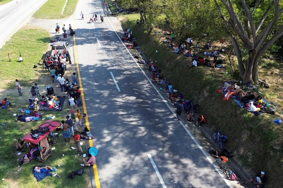 FILE PHOTO: A drone view shows migrants resting on the side of a road as part of a caravan bound to the northern border with the U.S., near Tres Picos, Chiapas state, Mexico November 28, 2024. REUTERS/Jose de Jesus Cortes/File Photo