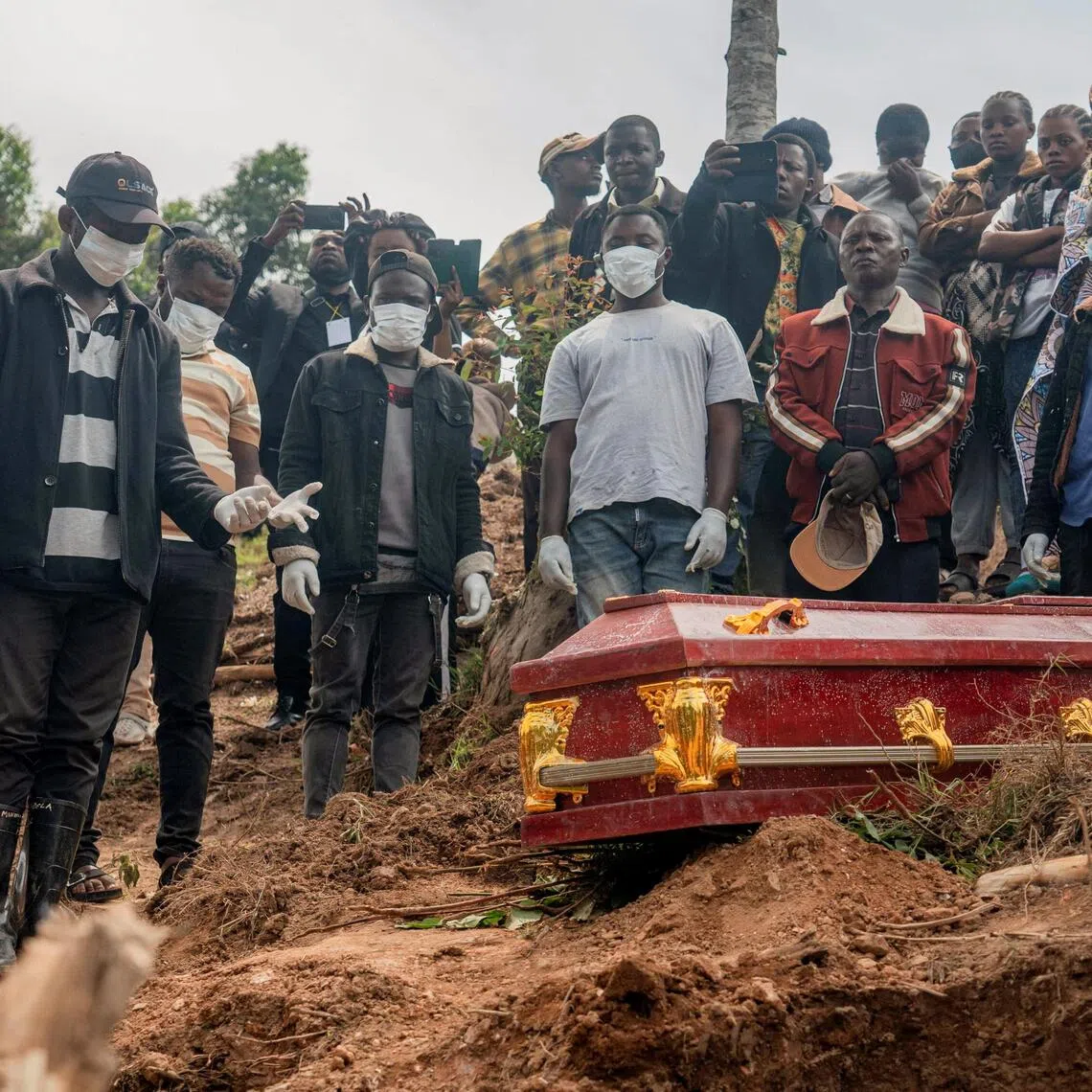 Relatives attending the funeral of an eight-month pregnant Congolese woman, who died of Ebola, and her foetus in Butembo, Democratic Republic of Congo on Oct 5.