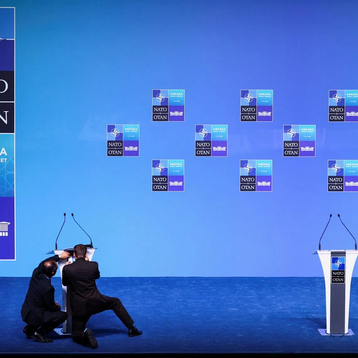 People adjust a lectern in the main press conference room a day before the start of the NATO summit in Ankara, Turkey, July 6, 2026. REUTERS/Yves Herman