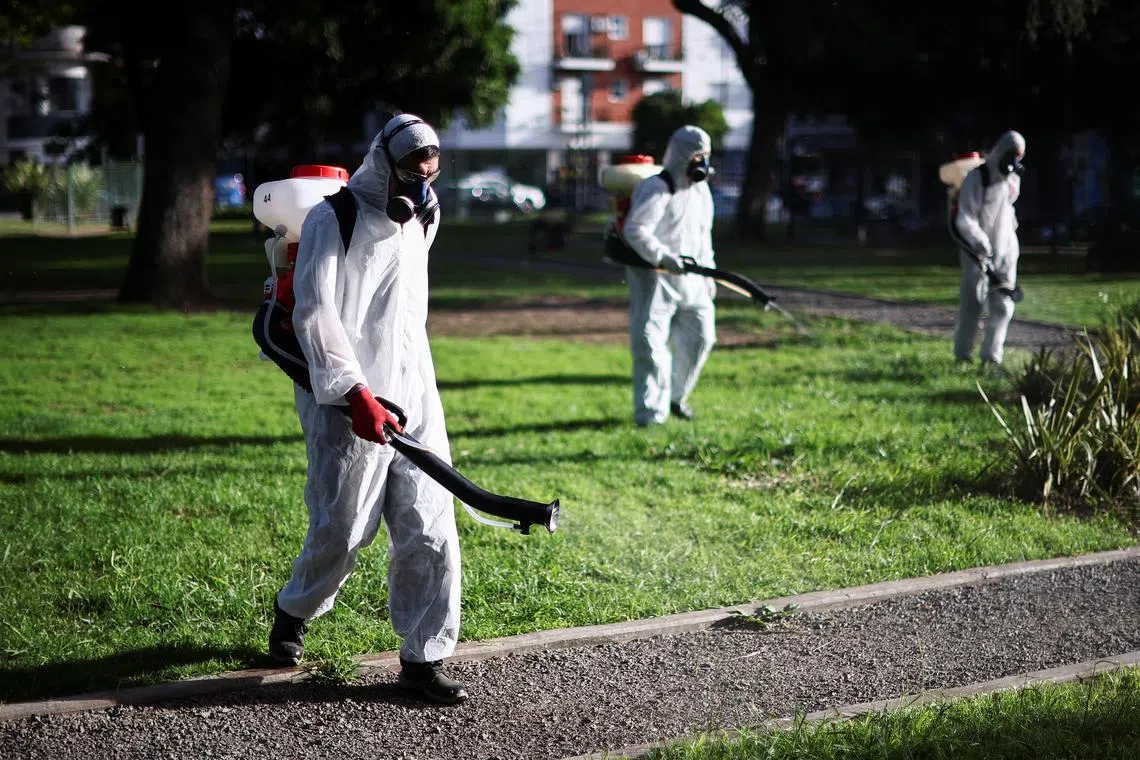 Health worker Javier Bellanzoni sprays insecticide to kill mosquitoes at a public park as dengue cases spike during a major outbreak, in Buenos Aires, Argentina March 26, 2024. REUTERS/Agustin Marcarian