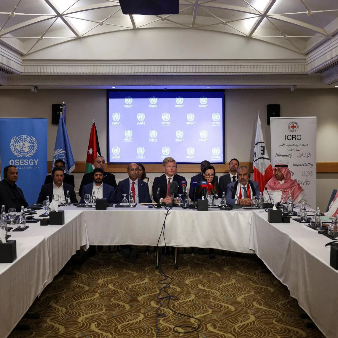 Christine Cipolla from the International Committee of the Red Cross (ICRC) speaks as she sits next to Hans Grundberg, UN Special Envoy for Yemen, as members of the Supervisory Committee on the Detainees Release Agreement attend the closing ceremony of a meeting between the Yemeni government and the Houthi group, in Amman, Jordan, May 14, 2026. REUTERS/Alaa Al Sukhni