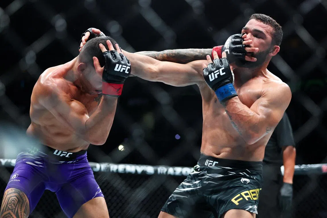 Patricio Pitbull (blue gloves) fighting Dan Ige in UFC 318 at Smoothie King Centre in New Orleans, Louisiana on July 19, 2025.