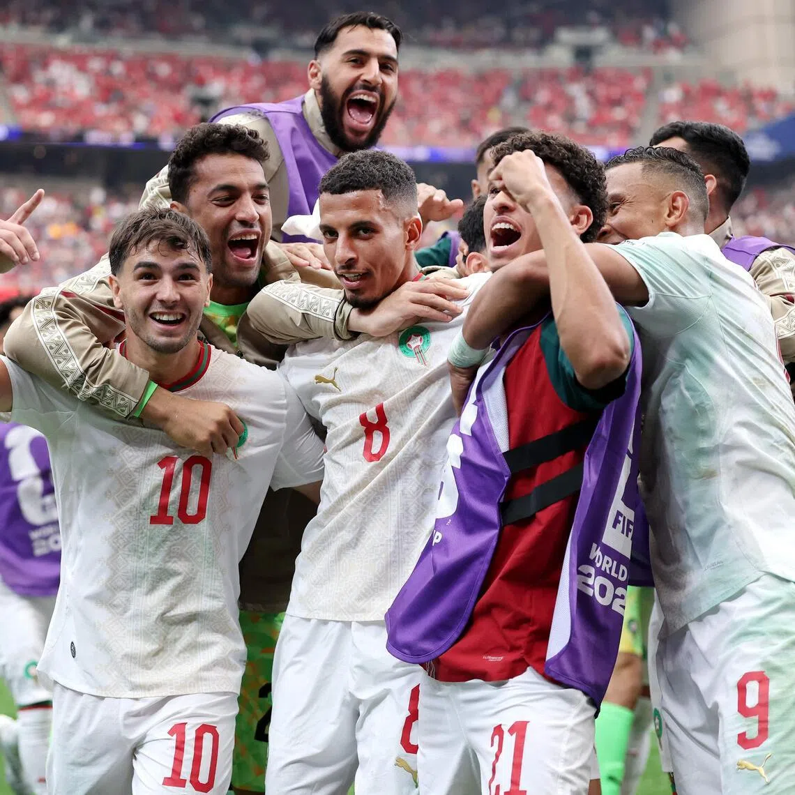 Azzedine Ounahi (No. 8) celebrating with his Morocco teammates after his two-goal performance inspired the African side to a 3-0 World Cup last-16 win over co-hosts Canada on July 4.