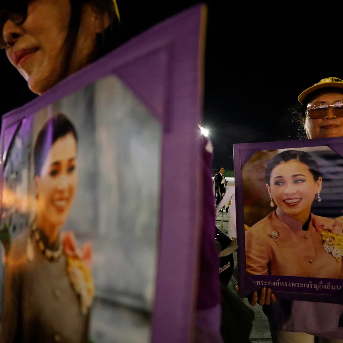 Well-wishers holding candles and portraits of Queen Suthida during her 48th birthday celebrations at Sanam Luang in Bangkok, Thailand, on June 3, 2026.