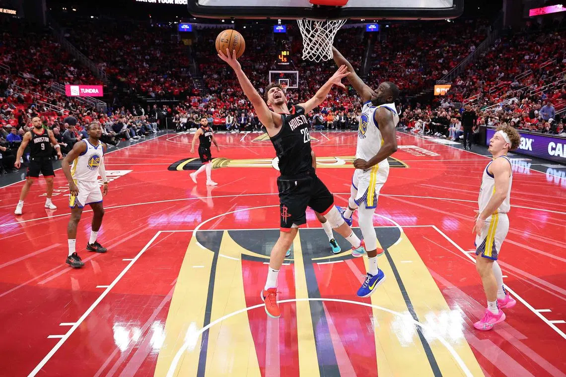 Alperen Sengun of the Houston Rockets shoots against Draymond Green of the Golden State Warriors during their NBA Cup clash.