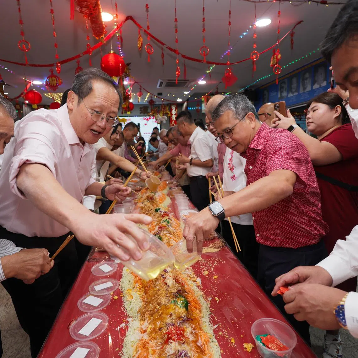 (Second From left): MPs of Marine Parade GRC, Dr Tan See Leng; and Mr Edwin Tong; taking part in lohei during the Geylang Cultural Organisations and Clan Associations Spring Reception 2025, on Feb 6, 2025.