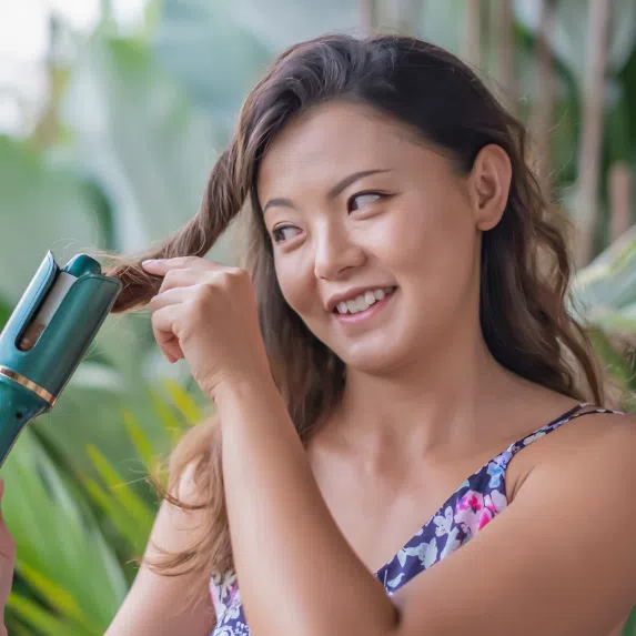 Best automatic hair curlers in Singapore: Asian woman curling hair with automatic hair curler