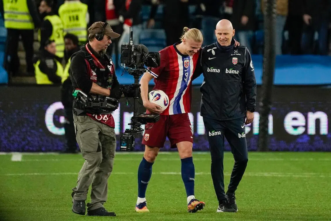 Norway's Erling Haaland celebrates with coach Stale Solbakken after their 5-0 victory over Israel.