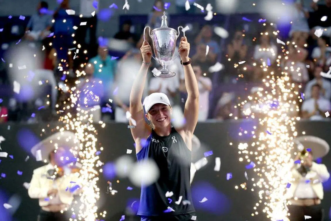 Tennis - WTA Finals - Cancun, Mexico - November 6, 2023 Poland's Iga Swiatek celebrates with the trophy after winning her final match against Jessica Pegula of the U.S. REUTERS/Henry Romero/File Photo