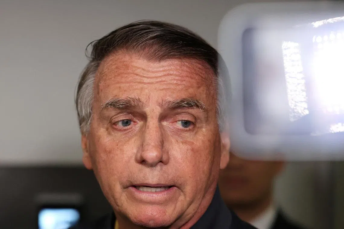 Former Brazilian President Jair Bolsonaro speaks as he leaves the Liberal Party headquarters in Brasilia, Brazil, July 24, 2025. REUTERS/Jorge Silva