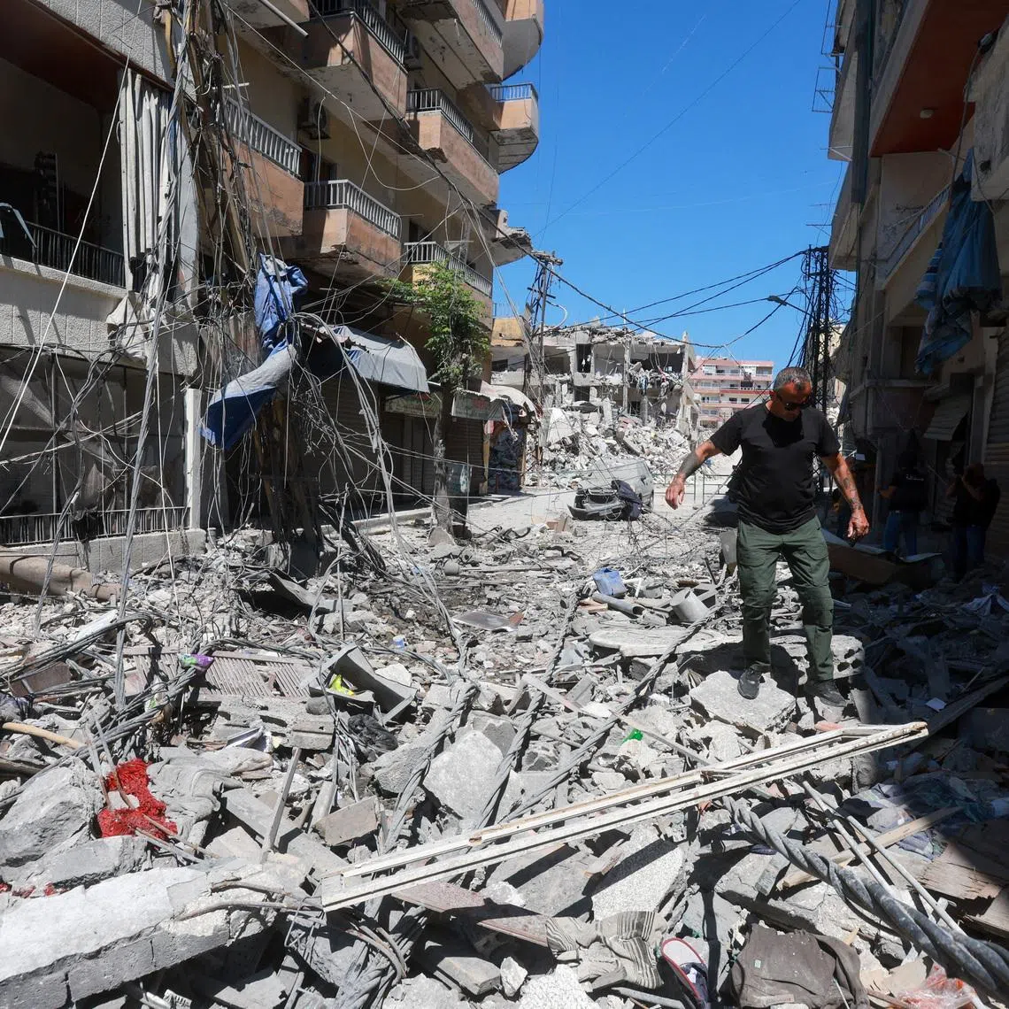 A man walks on rubble at the site an Israeli strike in Tyre, Lebanon, June 12, 2026. REUTERS/Aziz Taher
