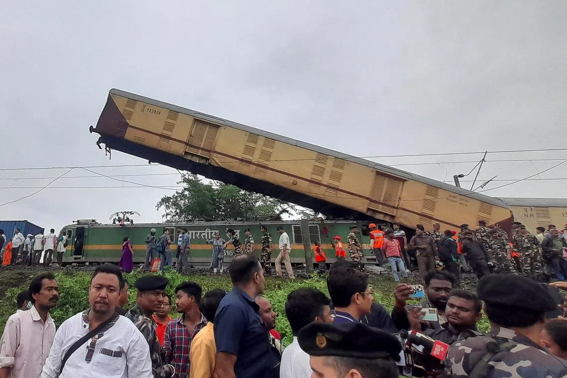 FILE PHOTO: Rescue workers along with people gather at the site of a train collision after the accident in Darjeeling district in West Bengal state, India, June 17, 2024. REUTERS/Stringer/File Photo