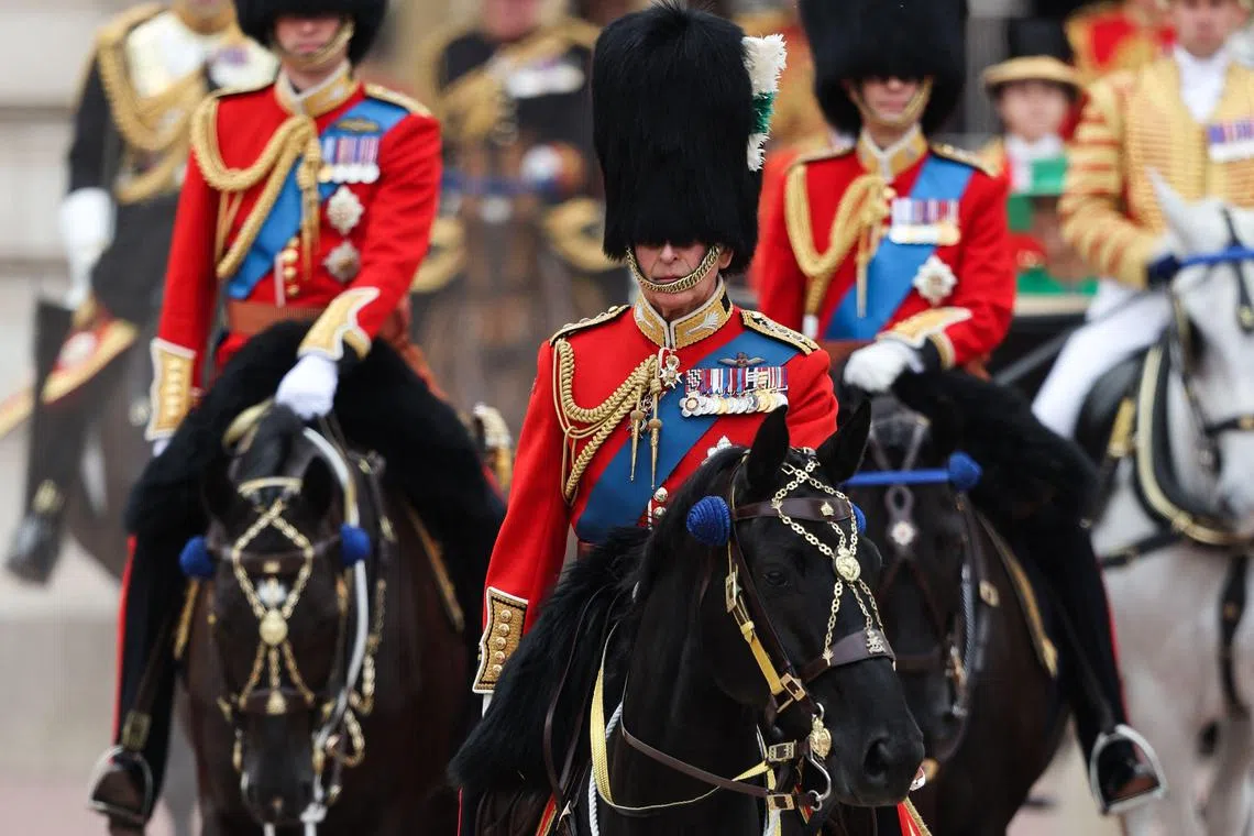 Britain's King Charles III (C) leads Britain's Prince William, Prince of Wales (L) and Britain's Prince Edward, Duke of Edinburgh (R) on horseback, leaving Buckingham Palace to process to Horse Guards Parade for the King's Birthday Parade, 'Trooping the Colour', in London on June 17, 2023. The ceremony of Trooping the Colour is believed to have first been performed during the reign of King Charles II. Since 1748, the Trooping of the Colour has marked the official birthday of the British Sovereign. Over 1500 parading soldiers and almost 300 horses take part in the event. (Photo by Adrian DENNIS / AFP)