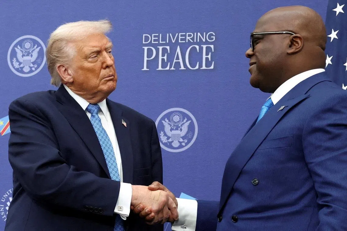 FILE PHOTO: U.S. President Donald Trump shakes hands with President of the Democratic Republic of the Congo Felix Tshisekedi during a signing ceremony at the U.S. Institute of Peace in Washington, D.C., U.S., December 4, 2025. REUTERS/Kevin Lamarque/File Photo