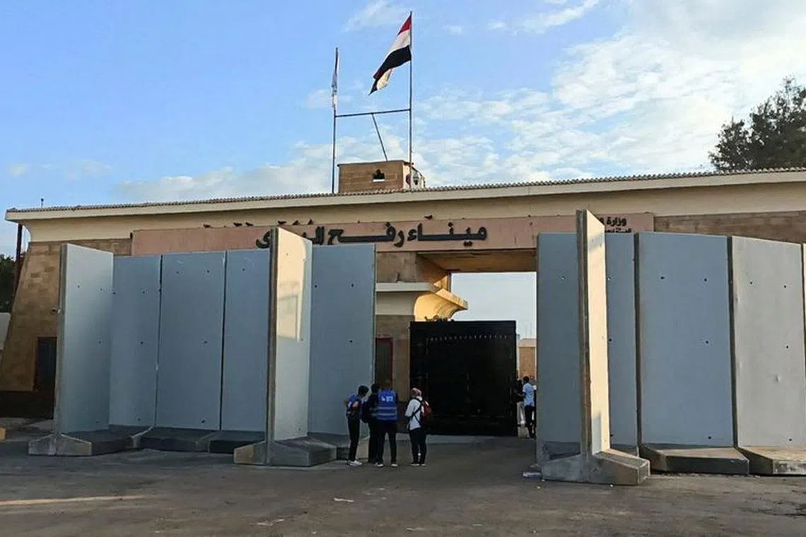 FILE PHOTO: Egyptian volunteers wait at the Rafah crossing in Egypt October 17, 2023. Trucks carrying humanitarian aid for Palestinians await a decision for it to open, to enter to enter Gaza, amid the ongoing conflict between Israel and the Palestinian Islamist group Hamas. REUTERS/Stringer/File Photo