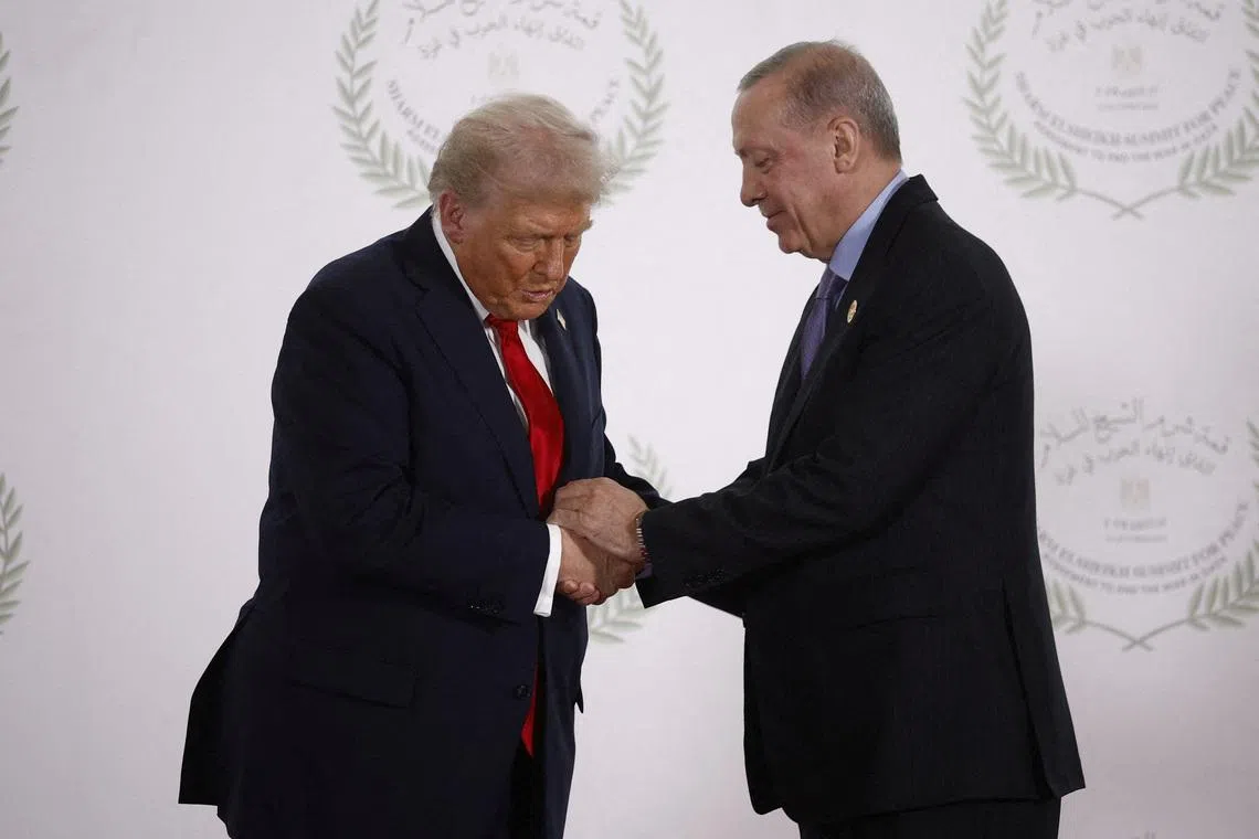 FILE PHOTO: U.S. President Donald Trump and Turkish President Tayyip Erdogan shake hands as they pose for a photo, at a world leaders' summit on ending the Gaza war, amid a U.S.-brokered prisoner-hostage swap and ceasefire deal between Israel and Hamas, in Sharm el-Sheikh, Egypt, October 13, 2025. Yoan Valat/Pool via REUTERS/File Photo