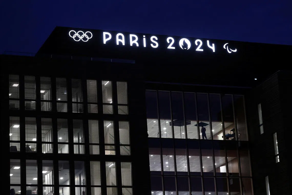 FILE PHOTO: The Olympics rings and the logos of the Paris 2024 Olympics and Paralympics Games are pictured on the Pulse building, the headquarters of the Paris 2024 Olympics organizing committee, in Saint-Denis near Paris, France, March 21, 2024. REUTERS/Stephanie Lecocq/File Photo