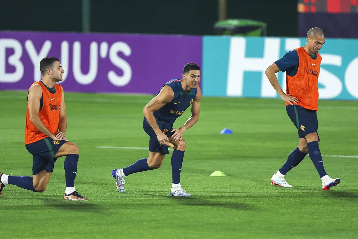From left: Portugal's Diogo Dalot, Cristiano Ronaldo and Pepe attend their team's training session in Al-Shahaniya, Qatar, on Thursday. 