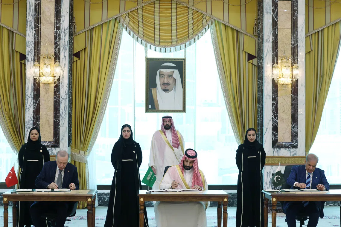 Turkish President Tayyip Erdogan, Saudi Crown Prince Mohammed bin Salman and Pakistan's Prime Minister Shehbaz Sharif sign a joint defense agreement in Mecca, Saudi Arabia, on Aug 7.