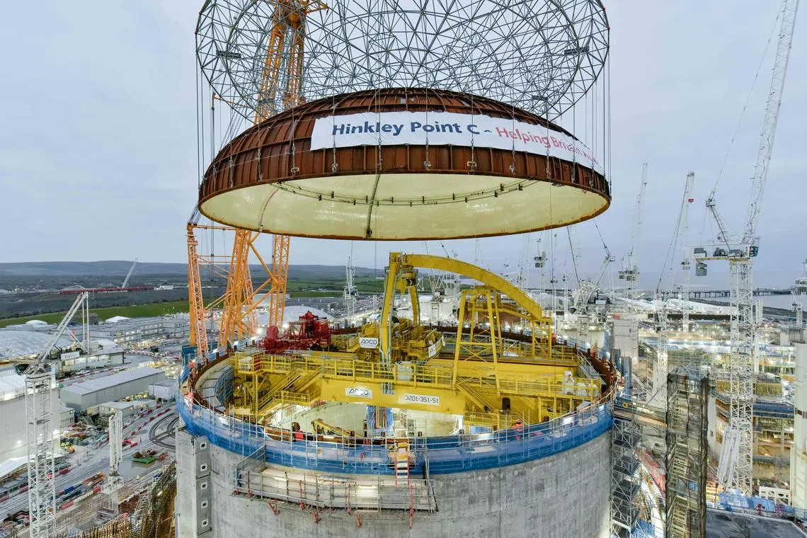 A 245-tonne steel dome being lifted onto Hinkley Point C's first reactor building near Bridgwater in south-west England on Dec 15.