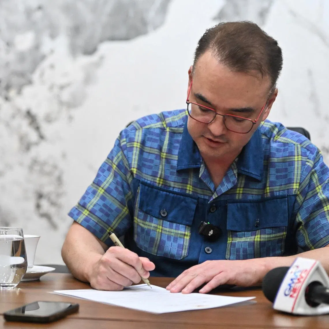 Philippine Senate President Alan Peter Cayetano signs the confirmation letter of the Articles of Impeachment against Vice President Sara Duterte at the Philippine Senate, in Pasay City, Metro Manila, Philippines, May 14, 2026. REUTERS/Noel Celis