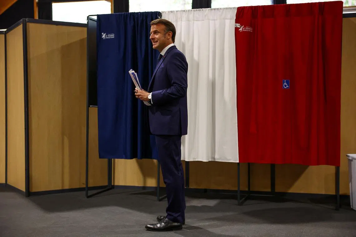 FILE PHOTO: French President Emmanuel Macron stands in front of voting booths during the European Parliament election, at a polling station in Le Touquet-Paris-Plage, France, June 9, 2024. REUTERS/Hannah McKay/Pool/File Photo