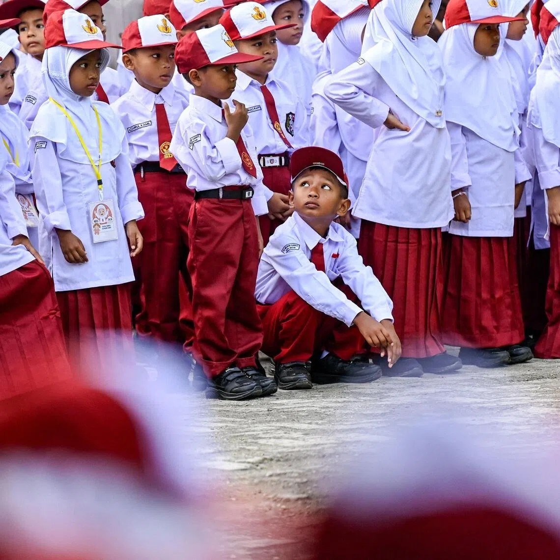 New students take part in a ceremony on the first day of elementary school in Darul Imarah on outskirts of the Banda Aceh on July 13.