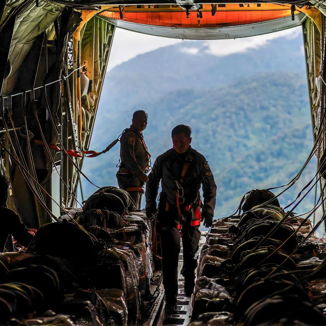 Indonesian Air Force personnel prepare to airdrop aid from a military transport aircraft in the flood-affected and isolated Gayo Lues area in Aceh on Dec 7.