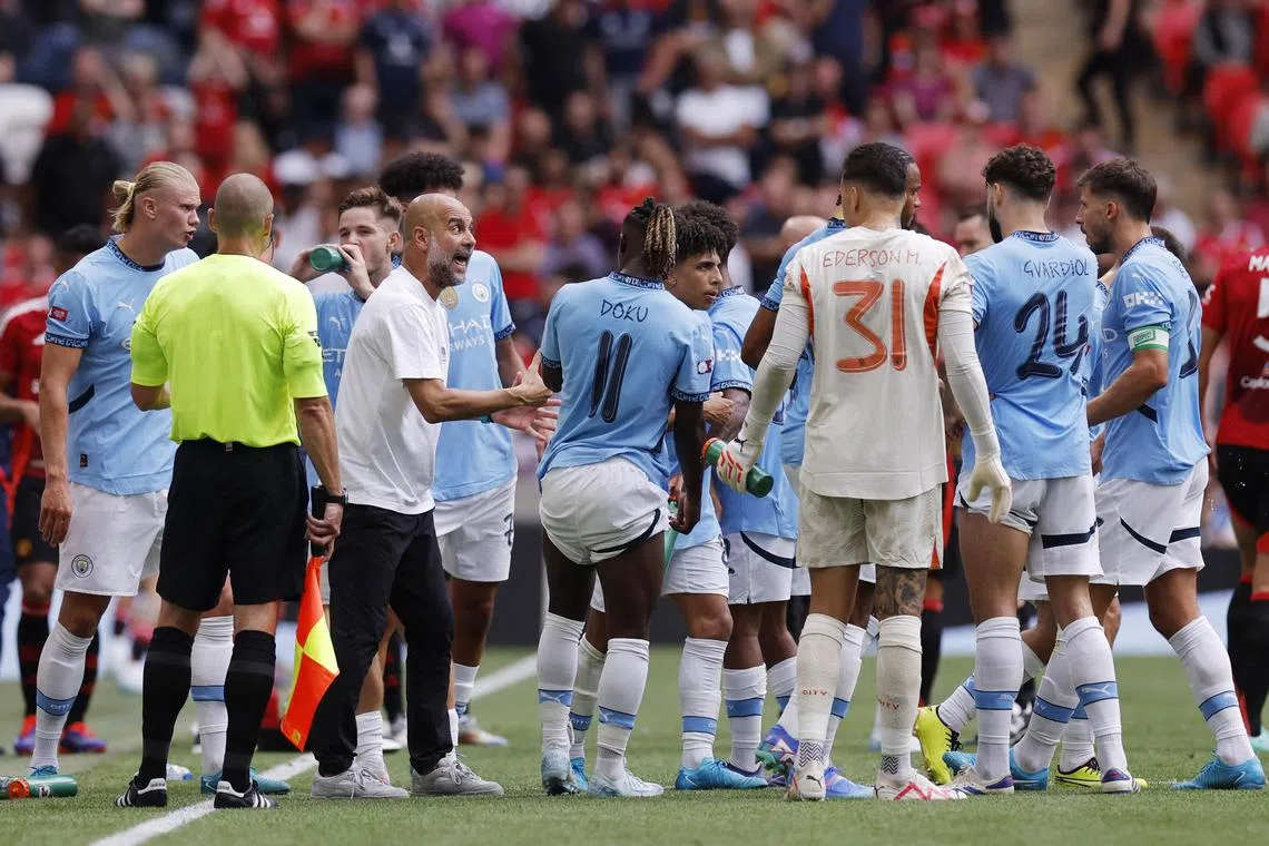 Soccer Football - Community Shield - Manchester United v Manchester City - Wembley Stadium, London, Britain - August 10, 2024
Manchester City manager Pep Guardiola talks to players during a break in play Action Images via Reuters/Andrew Couldridge