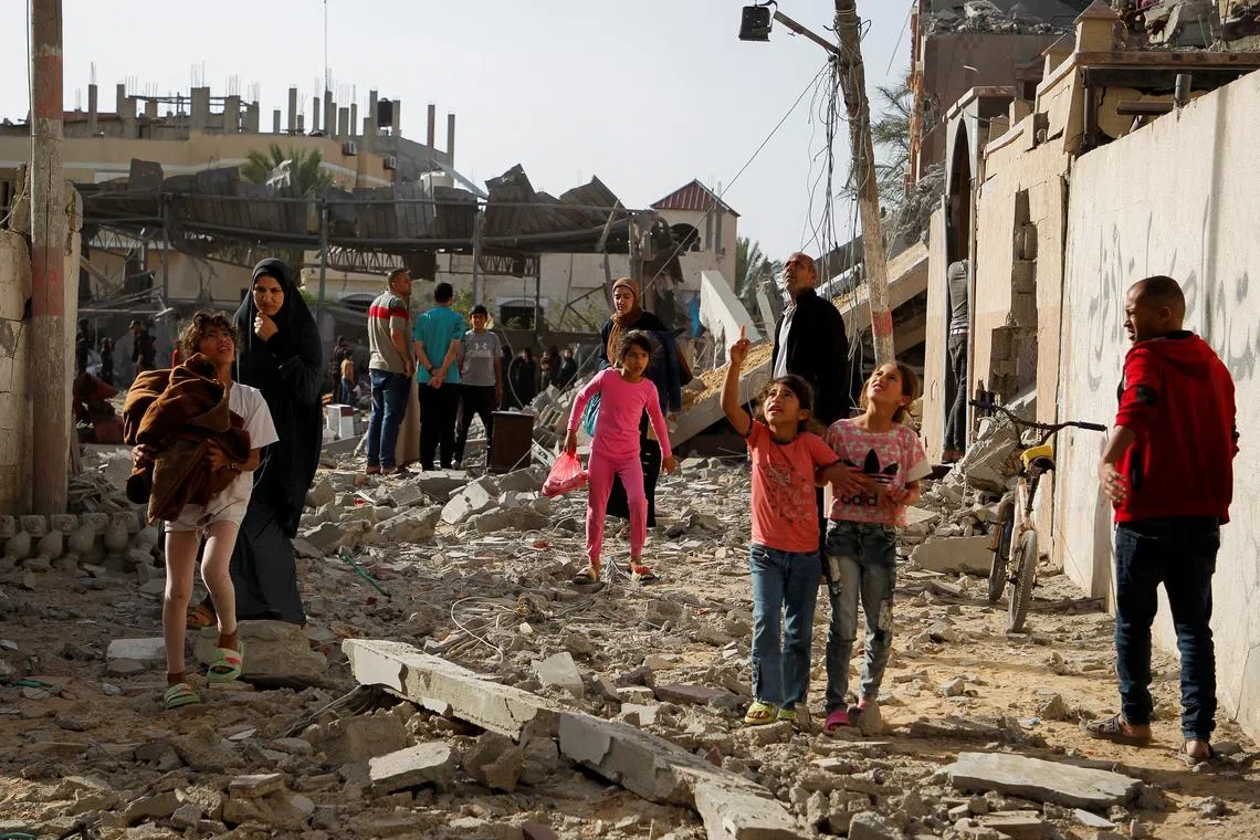 Palestinians at the site of an Israeli strike on a house, in Rafah, in the southern Gaza Strip, on May 5.