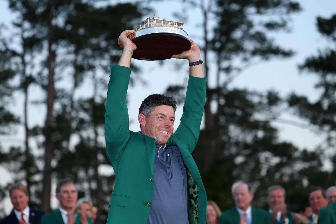 Rory McIlroy poses with the Masters trophy during the Green Jacket Ceremony after winning the tournament at Augusta National Golf Club.