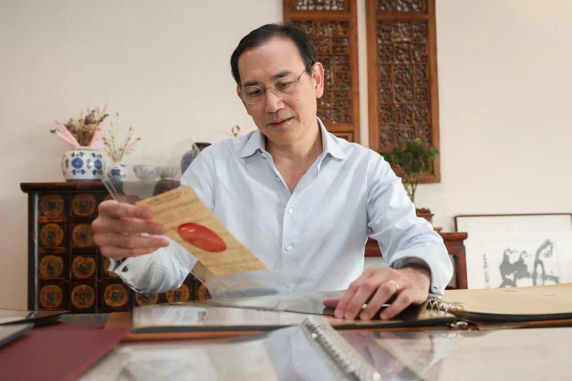 Dr Benjamin Seet looking through his 30 years collection of propaganda leaflets used in Singapore, Malaya & SEA (during WW2 & Malayan Emergency).