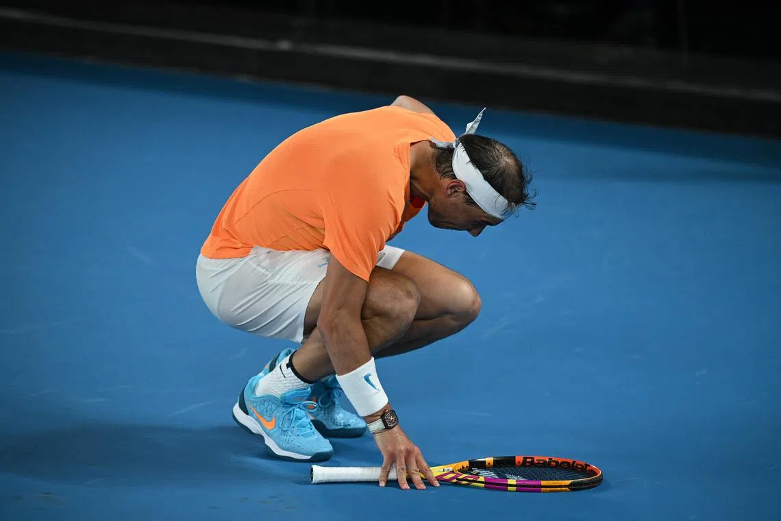 Rafael Nadal bends over injured during his match against Mackenzie McDonald at the Australian Open.