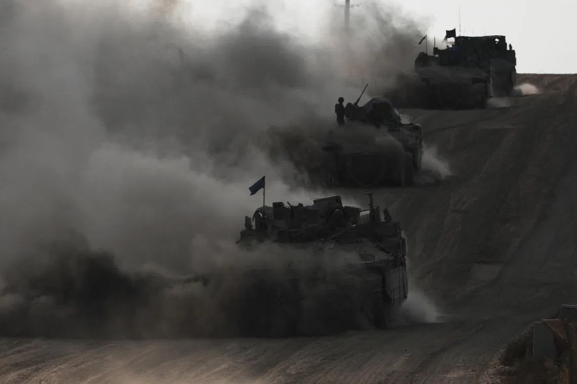 Israeli armoured personnel carriers (APC) operate, amid the ongoing conflict between Israel and the Palestinian Islamist group Hamas, near Israel's border with Gaza in southern Israel, May 29, 2024. REUTERS/Ronen Zvulun/File Photo