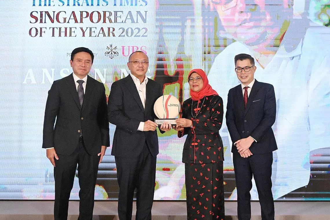 President Halimah Yacob (second right) presenting the Singaporean of the Year award to Mr Anson Ng. With them is UBS Asia-Pacific president Edmund Koh (left) and ST Editor Jaime Ho.