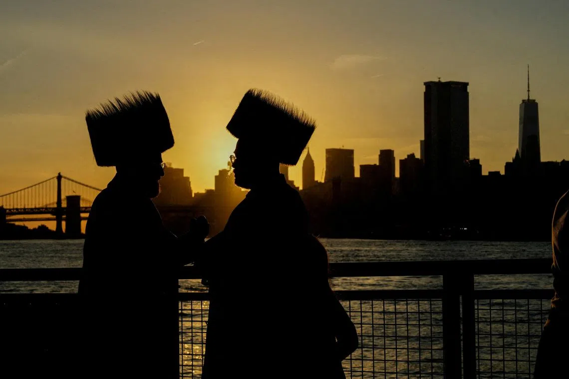 Ultra-Orthodox Jewish people performing the Tashlich ritual of symbolically casting away their sins during Rosh Hashanah, by the East River in New York City, U.S., on Oct 3, 2024. 