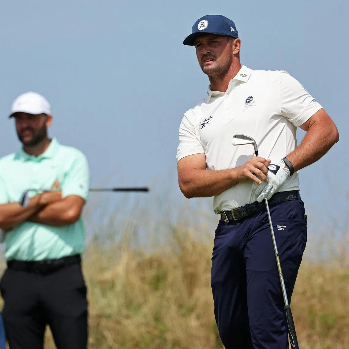 US golfer Bryson DeChambeau (right) watches his iron shot from the 12th tee on day one of the British Open on July 16.