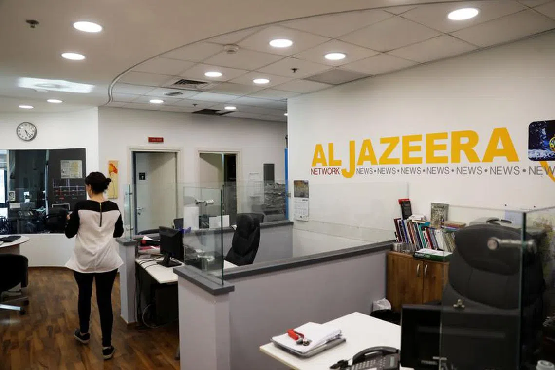 FILE PHOTO: An employee walks inside an office of Qatar-based Al-Jazeera network in Jerusalem June 13, 2017. Picture taken June 13, 2017. REUTERS/Ronen Zvulun/File Photo