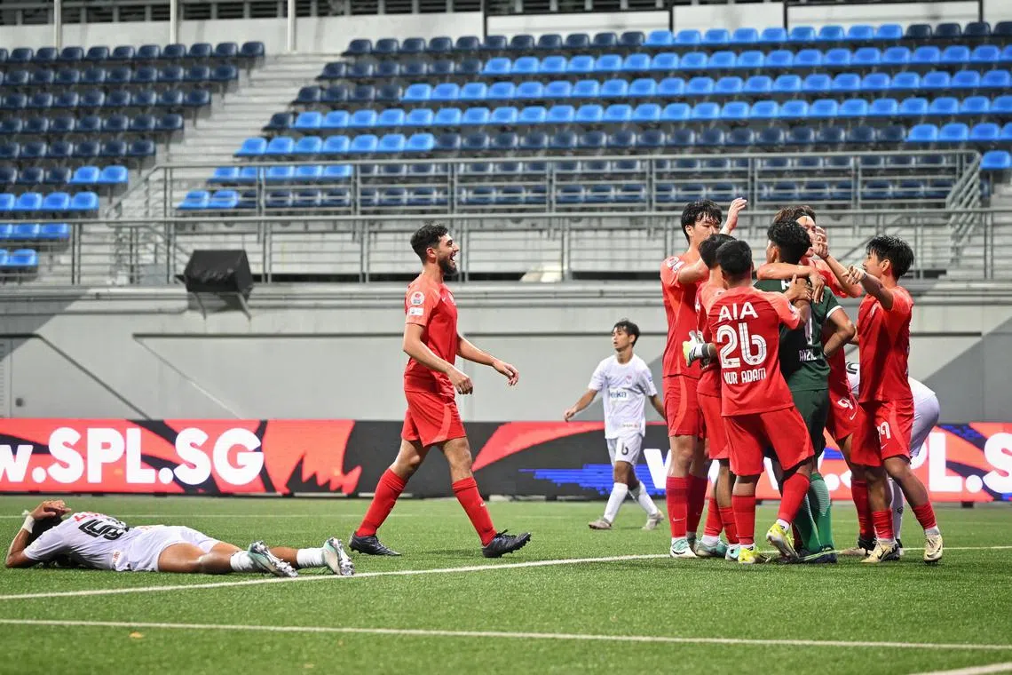 Several Young Lions players, including match winner Andrew Aw (far right, no. 19), embraced goalkeeper Aizil Yazid at the full-time whistle.
