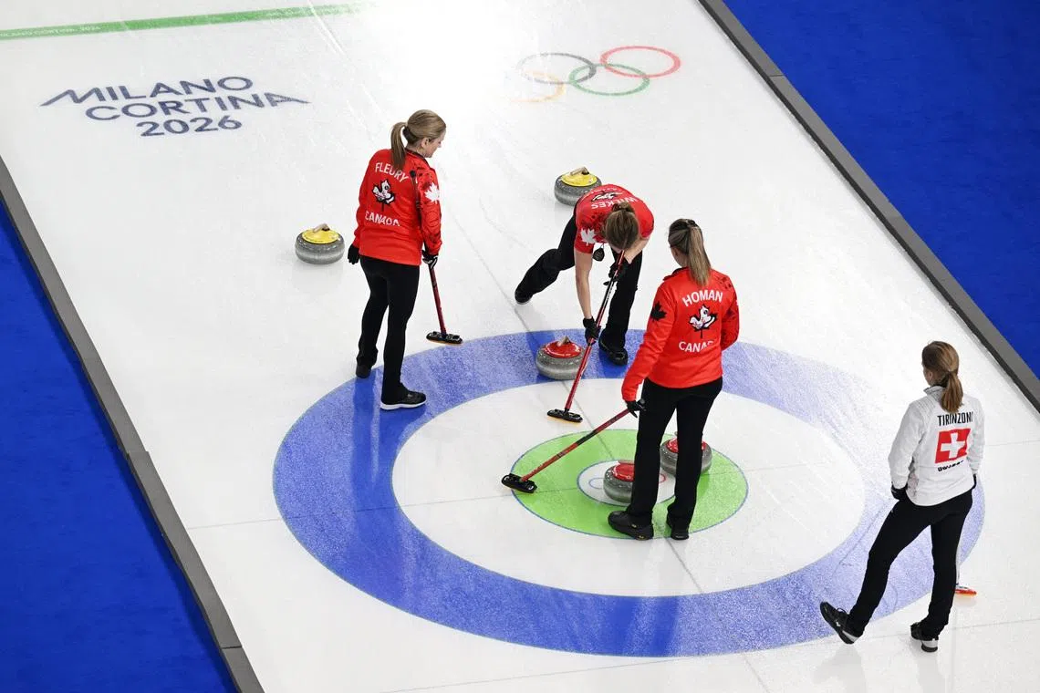 Milano Cortina 2026 Olympics - Curling - Women's Round Robin Session 5 - Canada vs Switzerland - Cortina Curling Olympic Stadium, Cortina d'Ampezzo, Italy - February 14, 2026. Sarah Wilkes of Canada, Tracy Fleury of Canada and Rachel Homan of Canada in action REUTERS/Jennifer Lorenzini