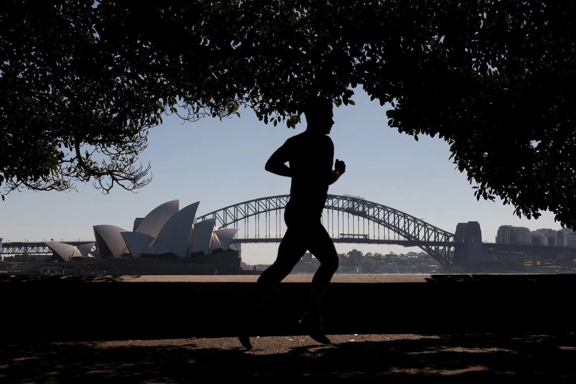 A man jogs along a harbourside path with Sydney Opera House and the Sydney Harbour Bridge in the background, on the first day of spring, in Sydney, Australia, September 1, 2026. REUTERS/Hollie Adams TPX IMAGES OF THE DAY